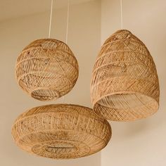 three wicker lamps hanging from the ceiling