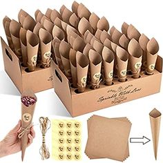 a cardboard box filled with lots of brown paper cones next to other boxes and papers