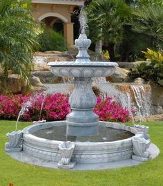 a water fountain in the middle of a garden