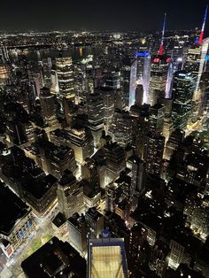 an aerial view of new york city at night from the top of the empire building