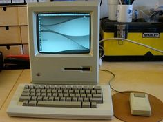 an old computer sitting on top of a wooden desk