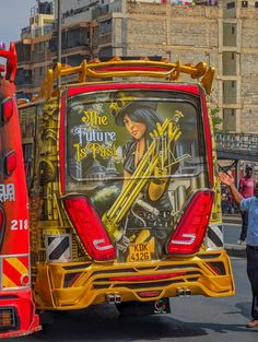 the back end of a bus with an advertisement on it's side and people walking by