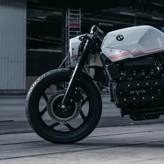 a white motorcycle parked in front of a building