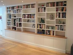 the bookshelves are lined up against the wall