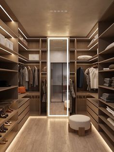 a walk - in closet with lots of shelves and shoes on the floor next to it