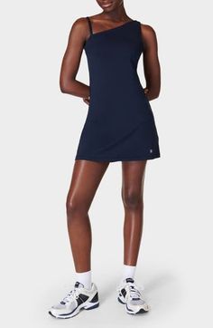 High-stretch fabric offers easy movement in this sporty dress with an asymmetric neckline, a removable strap and built-in shorts with drop-in side pockets. 31" length; 4" inseam; 18" leg opening (size Medium) One-shoulder neck Removable, adjustable strap Shelf bra Built-in shorts underneath with drop-in pockets Moisture-wicking fabric engineered for dryness and comfort 79% polyester, 21% elastane Machine wash, dry flat Imported Sporty Fitted Dress With Built-in Shorts, Workout Dress With Built-in Stretch Shorts, Stretch Mini Dress With Built-in Shorts, Summer Blue Mini Tennis Dress, Sleeveless Tennis Dress With Built-in Shorts, Fitted Dresses With Built-in Shorts, Stretch Short Tennis Dress For Sports, Short Stretch Tennis Dress For Sports, Stretch Short Length Tennis Dress For Sports