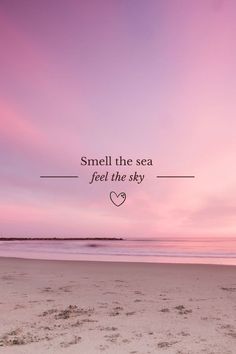 a pink sky with the words smell the sea, feel the sky on it and a heart in the sand