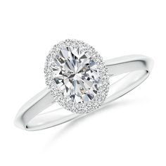 a white gold engagement ring with an oval diamond center