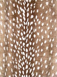 an animal print fabric with white spots on it