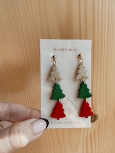 a pair of christmas tree earrings on a card