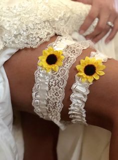 the woman is wearing sunflower garters on her thigh with lace and crochet