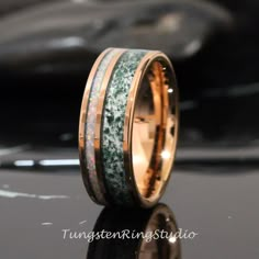 a wedding band with green and gold glitter inlays