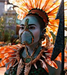 a woman with an elaborate headdress and face paint