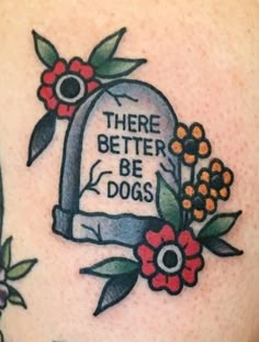 there is a tattoo on the back of a woman's shoulder that says, there better be dogs