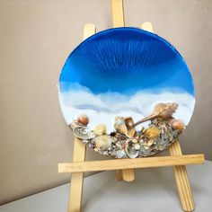 a blue plate sitting on top of a wooden easel