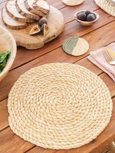 a wooden table topped with plates and bowls filled with food