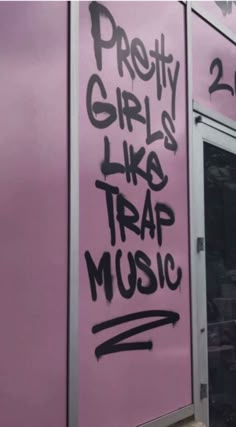 graffiti on the side of a pink building that says pretty girls like trap music written on it