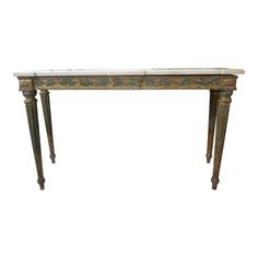 an antique console table with marble top