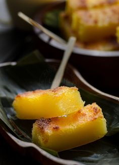 some food is sitting on a leafy plate with chopsticks in the middle