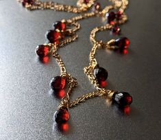 Emanating understated elegance, this gorgeous garnet piece glitters and glows in the sunlight. Each garnet briolette is meticulously handpicked for its flawless beauty and delicately wire-wrapped onto its chain. We only source the highest quality garnet as we love the deep dark red hue of these precious gems. This beautiful necklace is part of a set with an accompanying bracelet and earrings as part of our garnet collection. 💜 G E M S T O N E S 💜 * Gemstone: Natural Pyrope Garnet. * Size: 8mm Luxury Garnet Birthstone Necklace, Bohemian Garnet Necklace, Red Gemstone Necklace, Broken Bonds, Pyrope Garnet, Flawless Beauty, Garnet Pendant, Garnet Necklace, Necklace Red