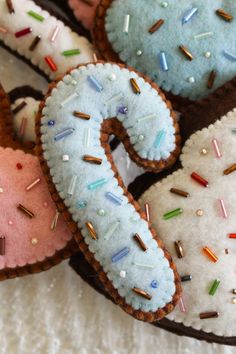 several decorated donuts with sprinkles and frosting in the shape of a number