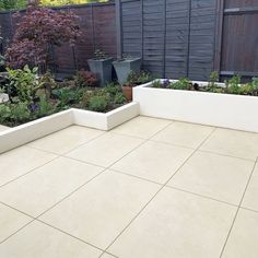 an outdoor patio with several planters in it