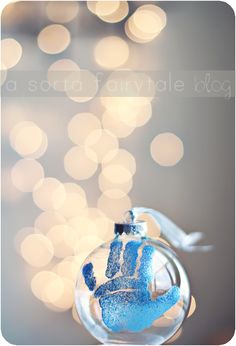 a glass ornament with a handprint on it