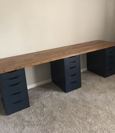 a wooden desk with four drawers in a room