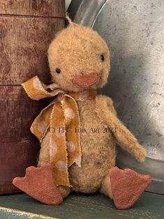 a brown teddy bear sitting on top of a shelf