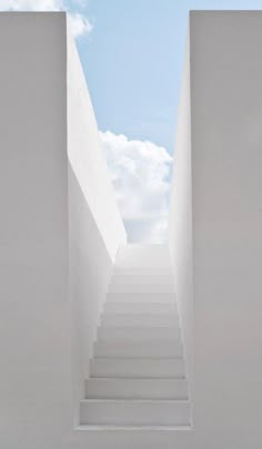 there is a white staircase going up to the sky