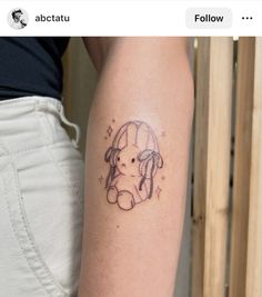 a woman's arm with a tattoo of a dog on the left side of her arm