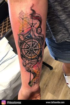 a person with a tattoo on their arm and the compass is in front of them