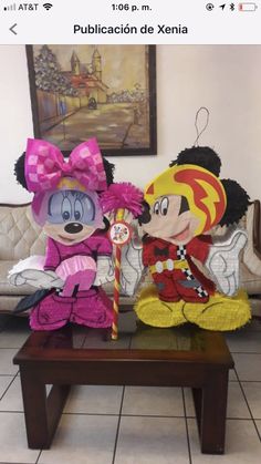 two stuffed animals sitting on top of a wooden table