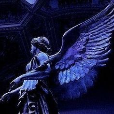 an angel statue with large wings in front of a blue background and ornate wallpaper