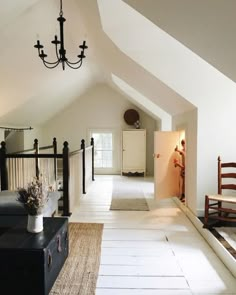 a room that has a couch and some chairs in it with a rug on the floor