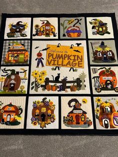 a quilt with pumpkin village pictures on it