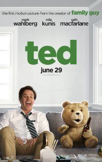 a man sitting on top of a couch next to a teddy bear in front of him