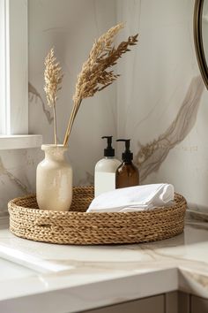 a bathroom counter with soap, lotion and flowers in a basket on top of it