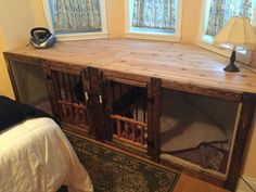 a bed room with two windows and a cat cage on top of the dressers