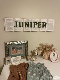 there are many items on the table in front of the sign that says, jumper