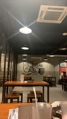 the inside of a restaurant with tables, chairs and signs on the wall that say go break