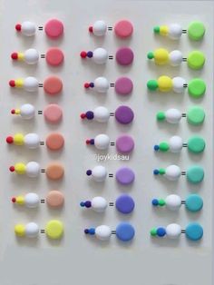 several different colored buttons on a white surface