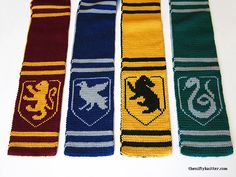 four knitted harry potter ties are lined up in a row on a white surface