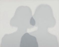 the shadow of two people in front of a white wall