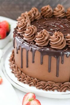 a chocolate cake with chocolate frosting and strawberries