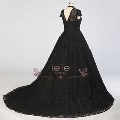 a black lace dress on display in front of a white background