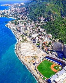 an aerial view of a baseball field next to the ocean