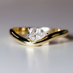 a gold ring with a white diamond on it