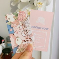 a person holding up a business card with flowers on it and the words noong work