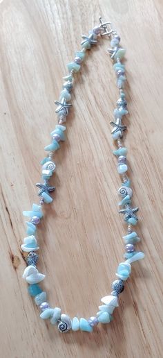 This necklace is made with starfish beads, conch shell beads, fish beads, tan seed beads, and turquoise chip beads. Toggle clasp. Measures 21 inches long end to end. Beaded Long Necklace, Ocean Beaded Necklace, Shell Necklace Diy, Marine Jewelry, Bracelets With Beads, Gemstone Accessories, Ocean Dress, Beachy Necklace